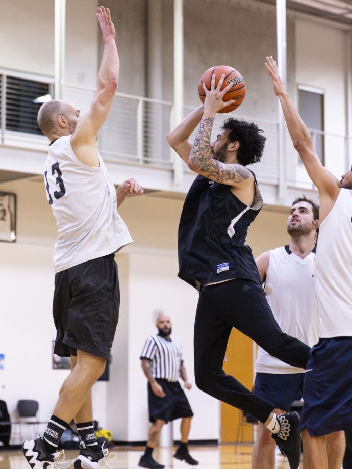 Action shot of a contested layup during a basketball game at the YMCA