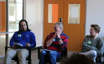 3 people chat at a social event at the YMCA
