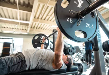 Image of man doing a bench press workout at the YMCA