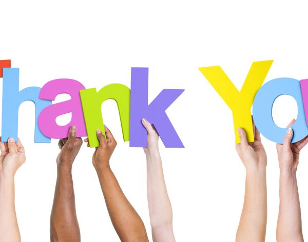 Image of individual hands holding up the letters to spell "thank you"