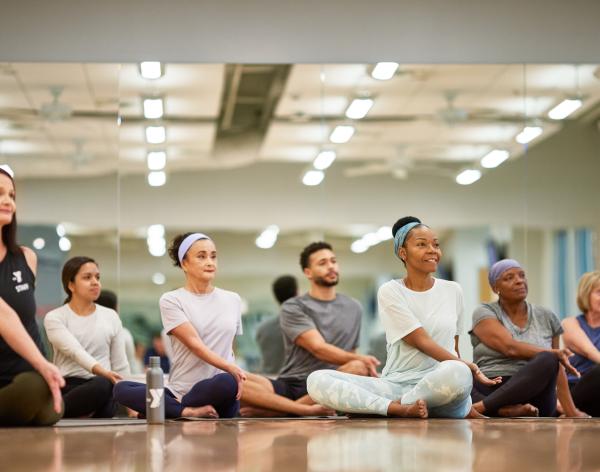 Instructor leads dance class in stretches at the YMCA