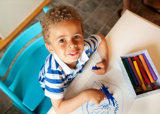 Drawing At Table At YMCA Child Care