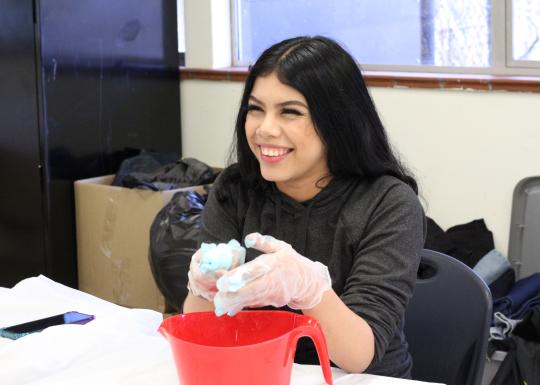 CLC student creating slime during art project time at the YMCA.