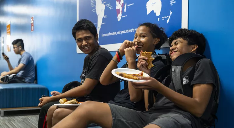 Late nite participants laugh over a pizza meal at the YMCA