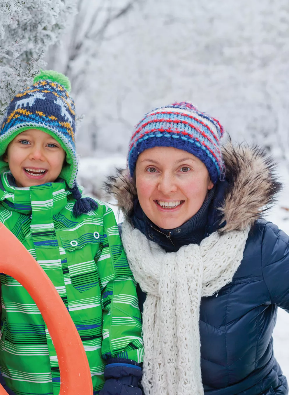 Mother and Son Smiling on Snowy Hill