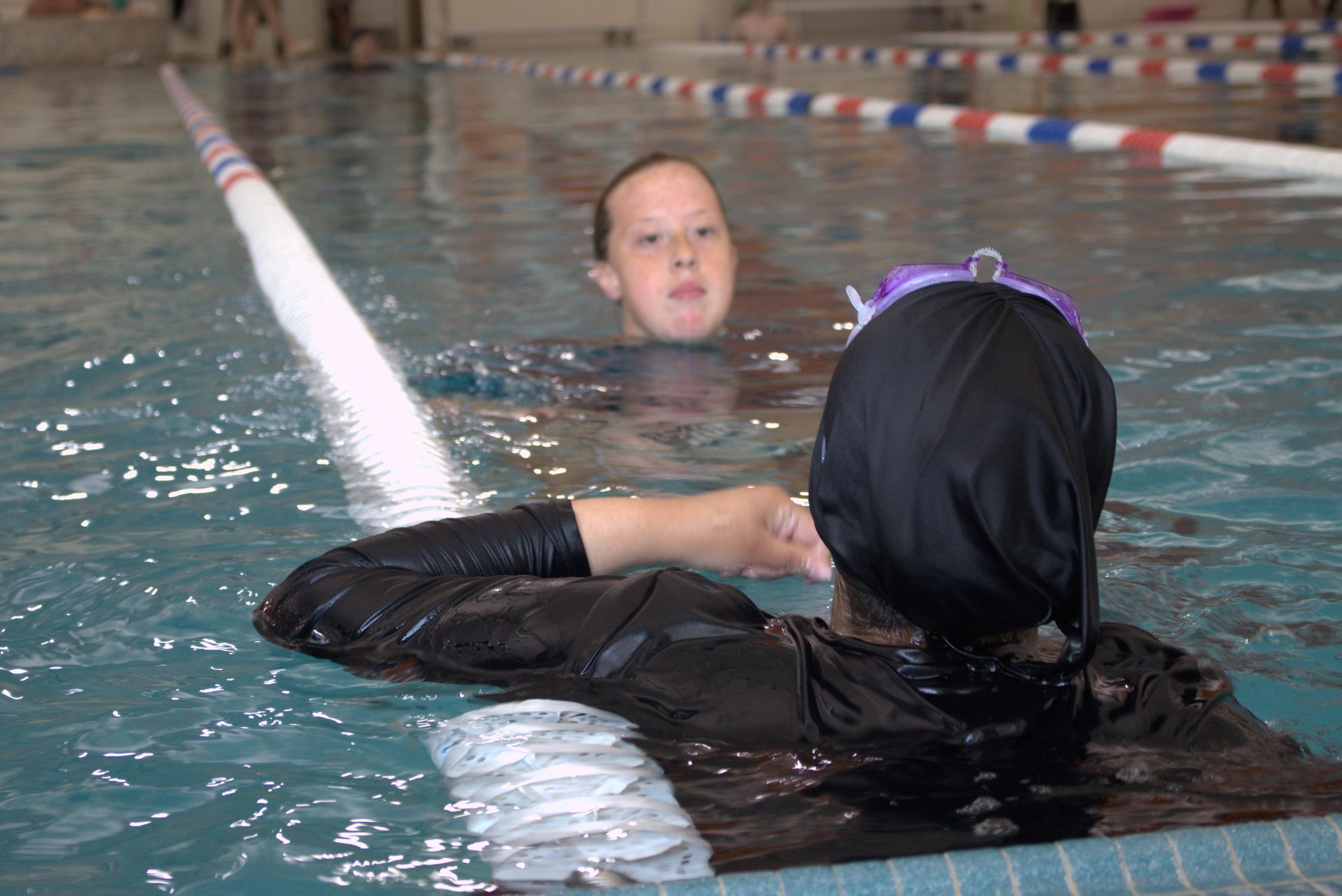 Lap swimmers having a conversation in the water during open swim at the YMCA