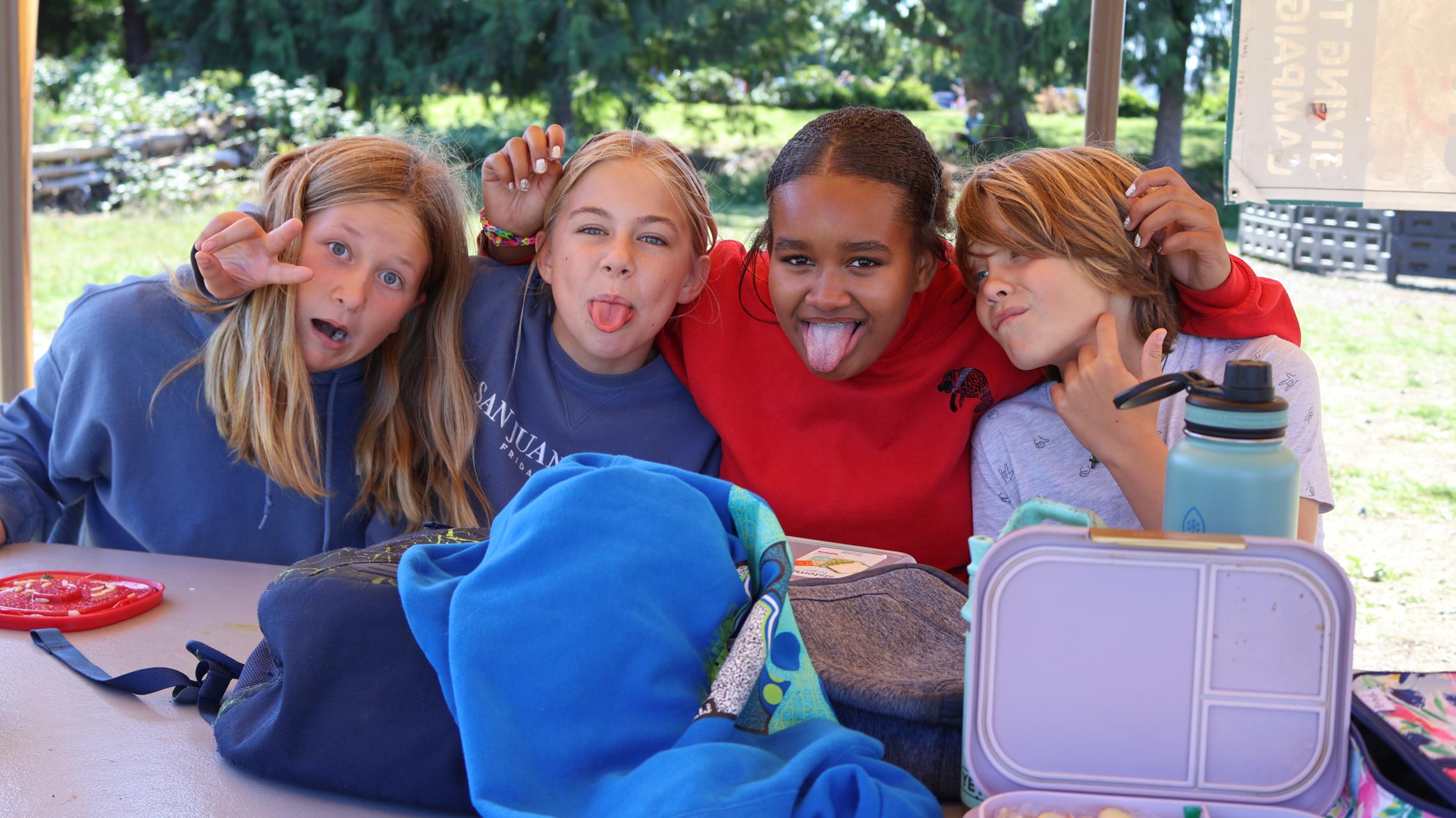 Campers pose for a picture during lunchtime at camp at the YMCA