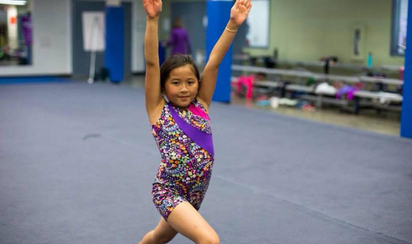 Girl Posing In YMCA Gymnastics Class