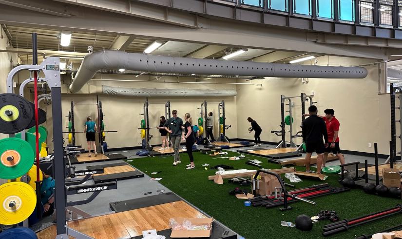 YMCA staff work to set up a renovated work out area