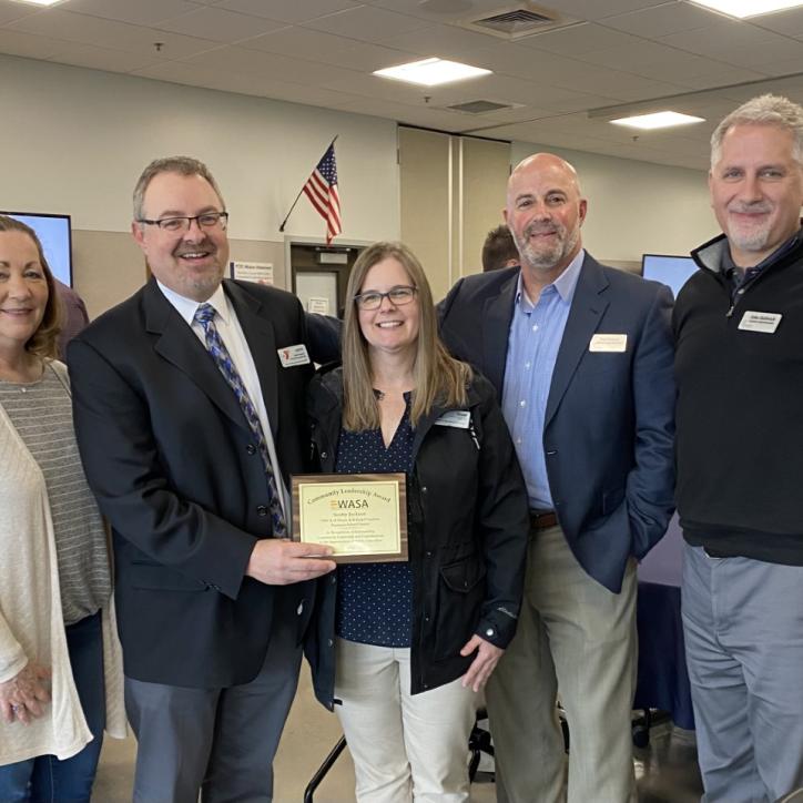 Karen Andersen, Scotty Jackson, Diane Jackson, Dan Gregory and John Hellwich stand together smiling as the YMCA of Pierce and Kitsap Counties accepts an award for its pandemic program -- Seymour Scholars-- which supported distance based learning for students.