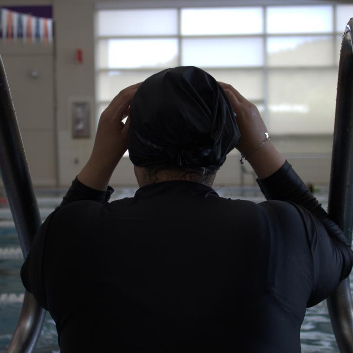 Shot of a swimmer adjusting their swim cap before starting some laps at the YMCA