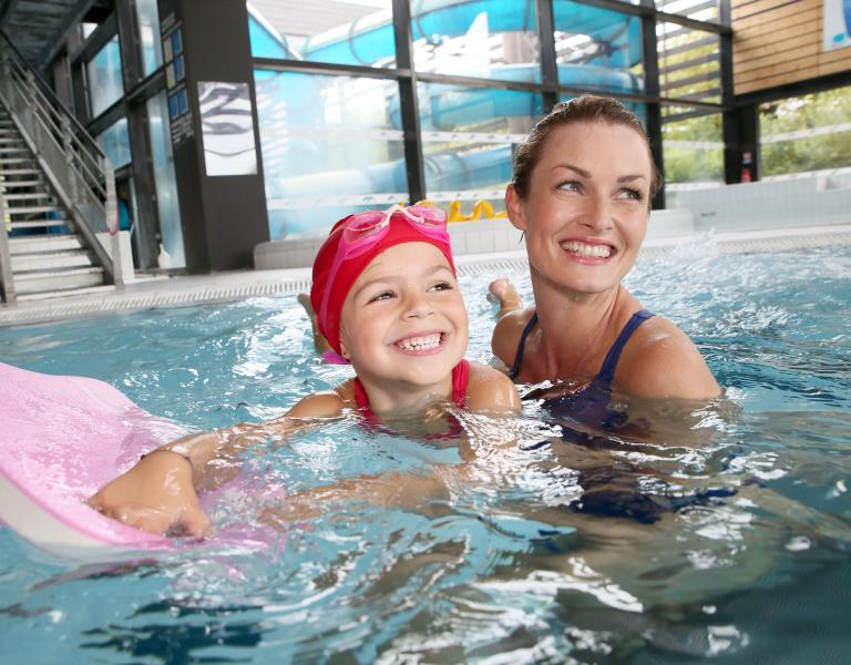 Mother and Daughter Having Fun In The Pool