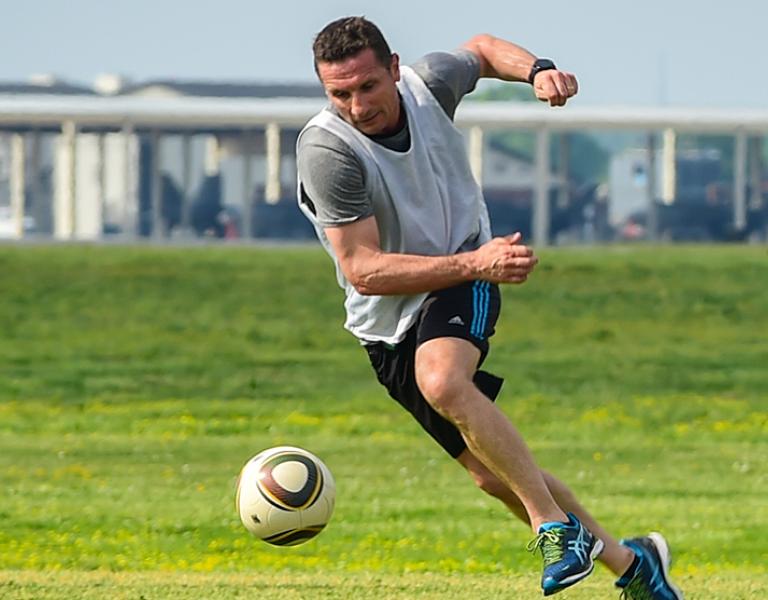 Action shot of a soccer player dribbling the ball down the field at the YMCA