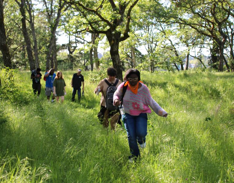 Community learning center students hike on a nature expedition at the YMCA