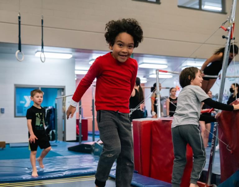 Boy in Red Jumping at YMCA Gymnastics