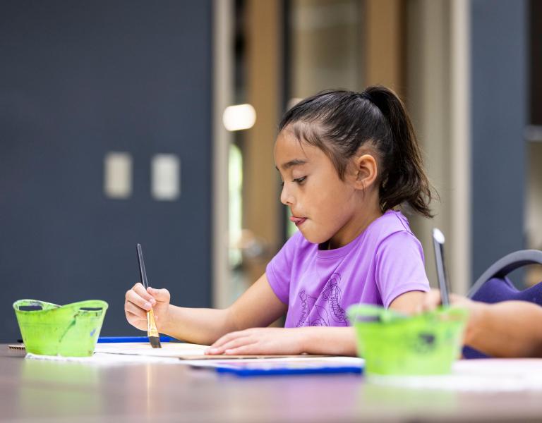 Concentrating on Painting at YMCA Arts Class