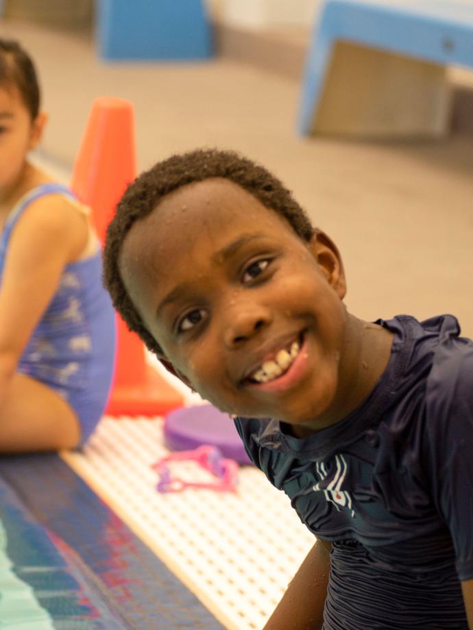 Smiling At The Pool Edge At YMCA Swim Lessons