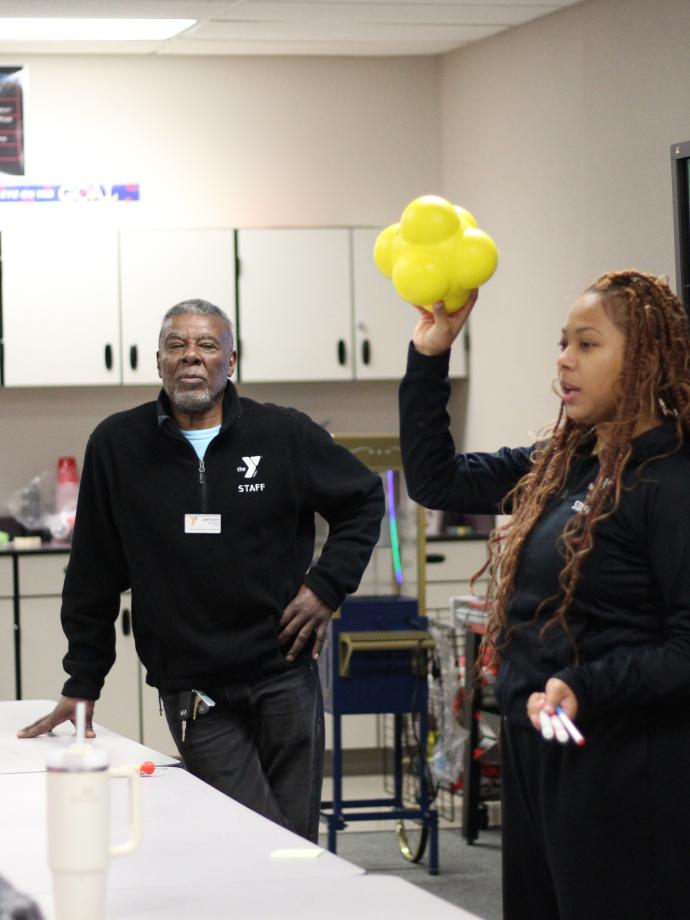 CCI Instructor leads a science lesson on molecules at the YMCA