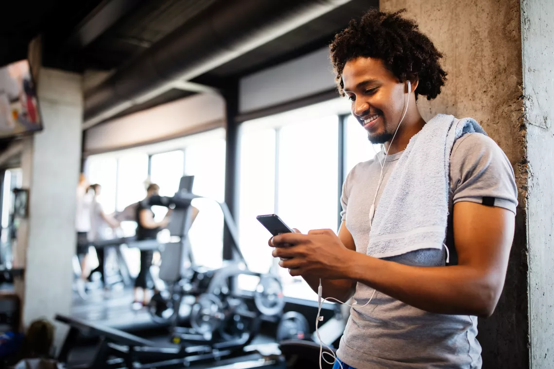 Guy logs workout in the Y360 app at the YMCA