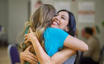 Two people embrace during Welcoming Week 2022
