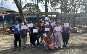CLC students pose with their academic achievement certificates at the YMCA