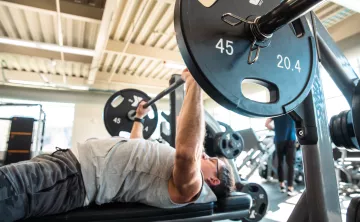 Image of man doing a bench press workout at the YMCA